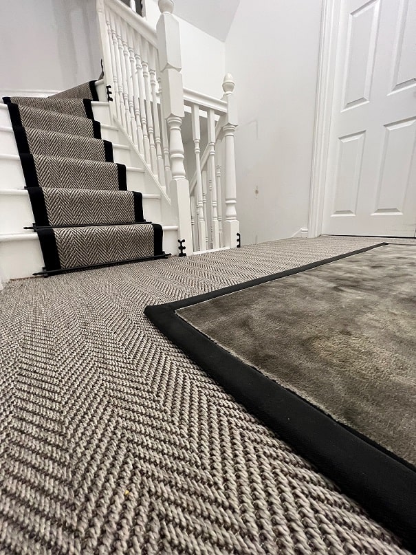 A luxury rug with a linen border and a bespoke stair runner with a cotton border supplied and installed by Flooring 4 You Ltd in Cheshire
